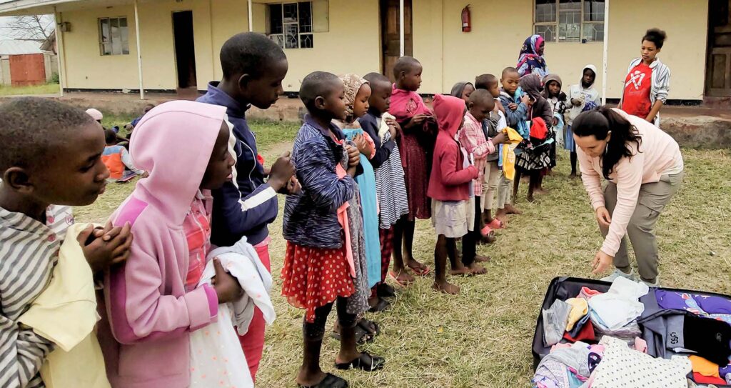 Distributing clothes to orphan children in Tanzania, Africa