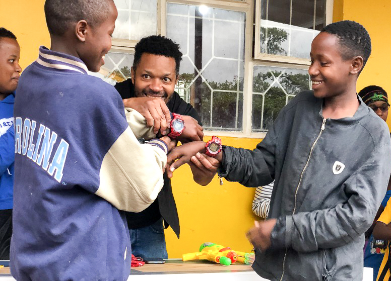 Orphan kids receiving watches for Christmas